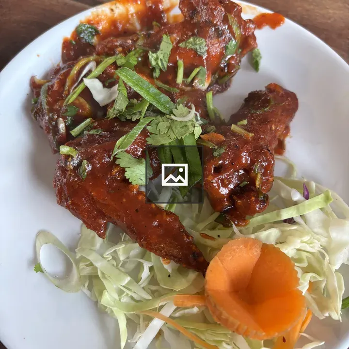 Chicken wings on plate with herbs