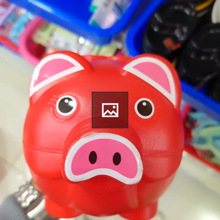 Red piggy bank against colorful backdrop
