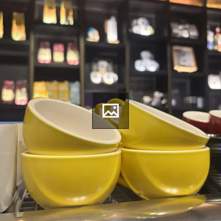 Four yellow ceramic cups
