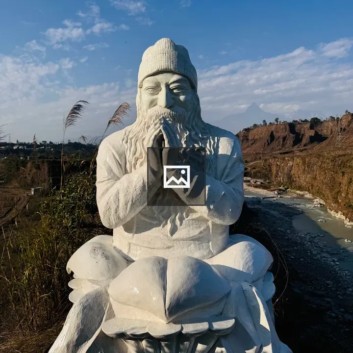 White OSHO statue on lotus pedestal