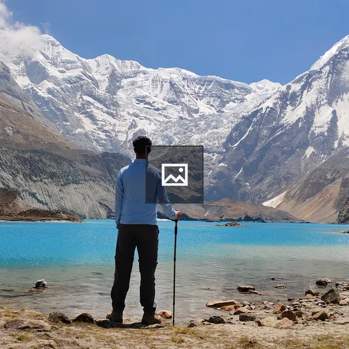 Person by Turquoise Alpine Lake