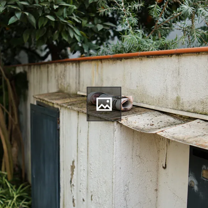 Rolled-up Newspaper on Outdoor Shelf