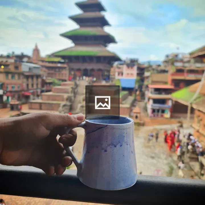 Holding Coffee with Nyatapolo Temple
