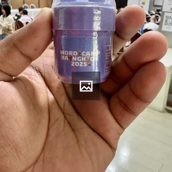 Hand Holding Purple Inhaler with WordCamp Bangkok Logo