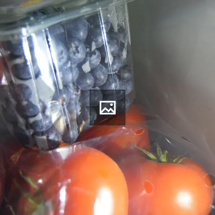 Fresh blueberries and tomatoes in fridge