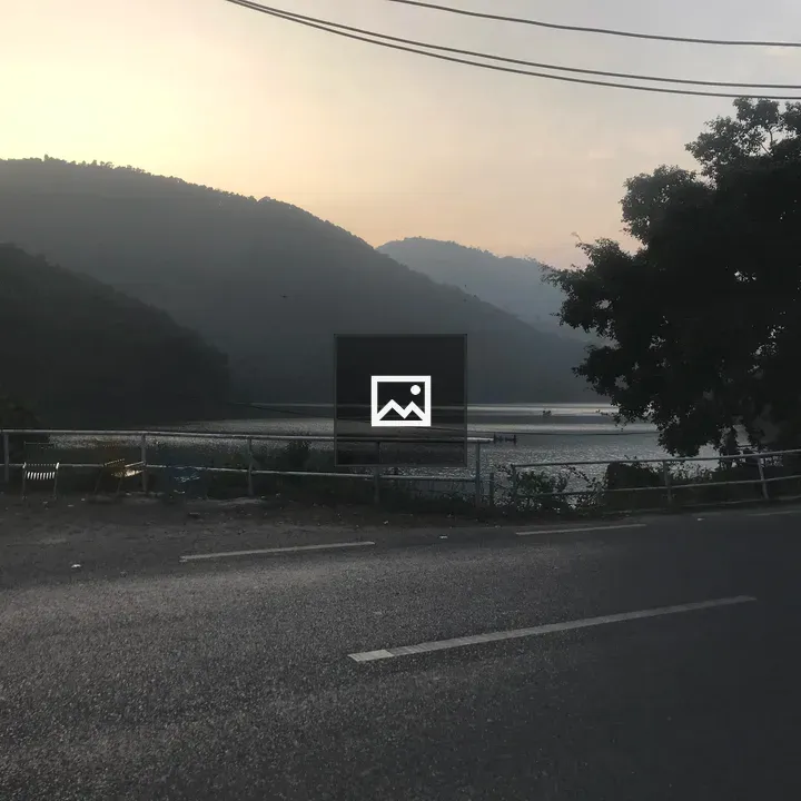 Silence road by river and hills