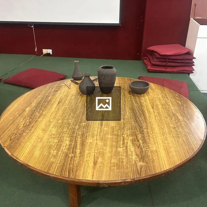 Round wooden table with clay pots