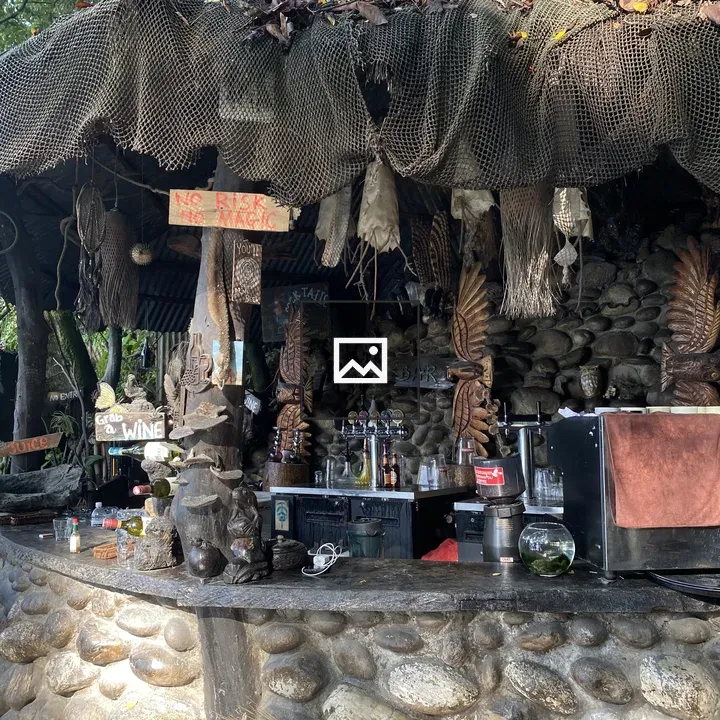 Rustic outdoor bar with thatched roof