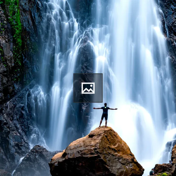 Man on Rock with Waterfall