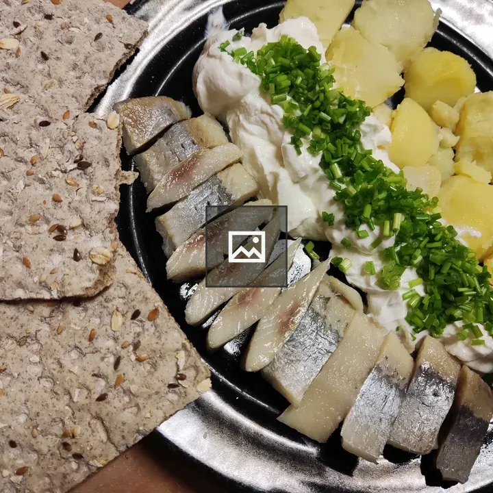 Herring with potatoes and gzik on plate