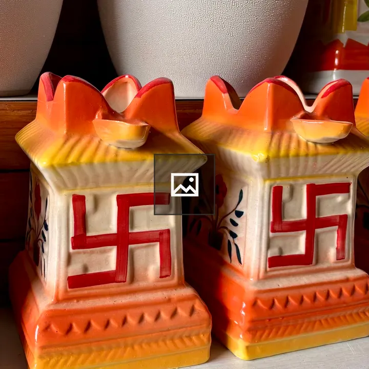 Two ceramic boxes with red swastikas