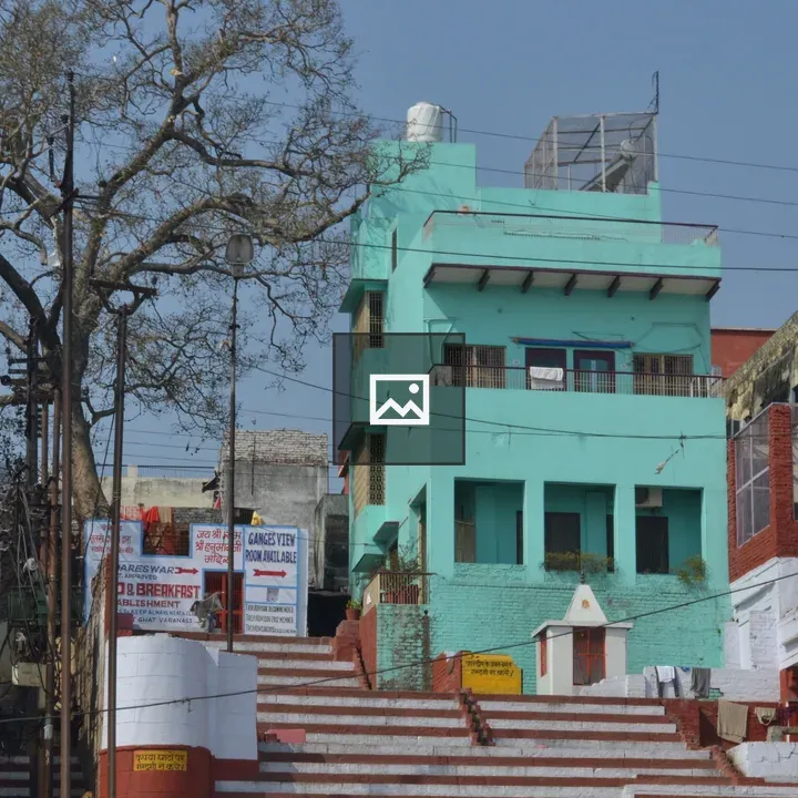 Colourful green building by river ghat