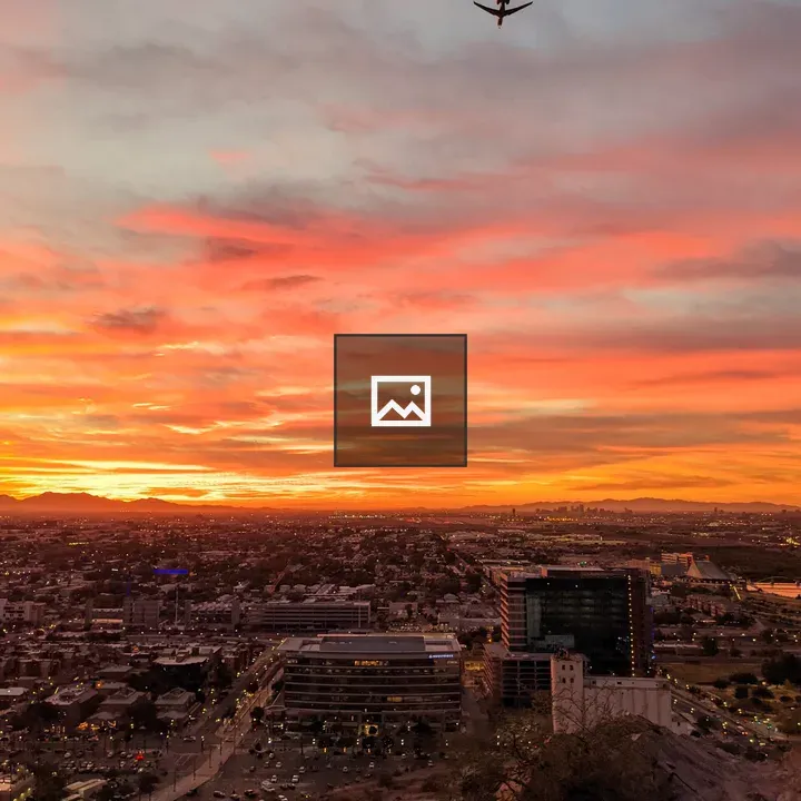 City at Sunset with Plane