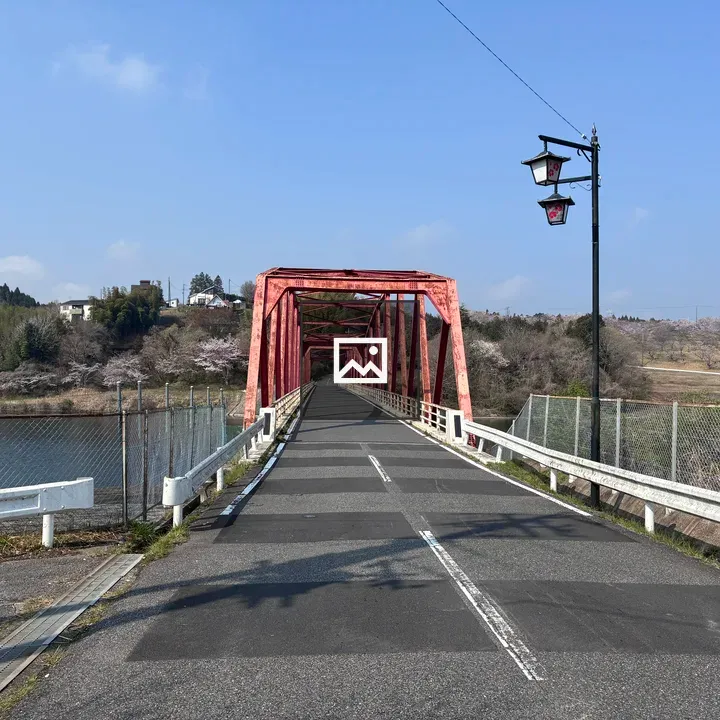Red bridge over calm water