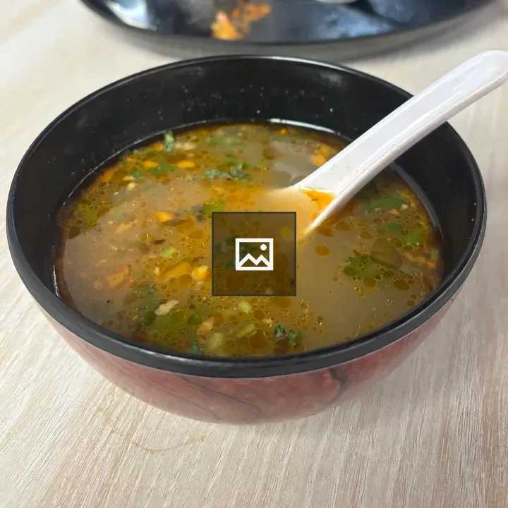 Chicken soup in black bowl