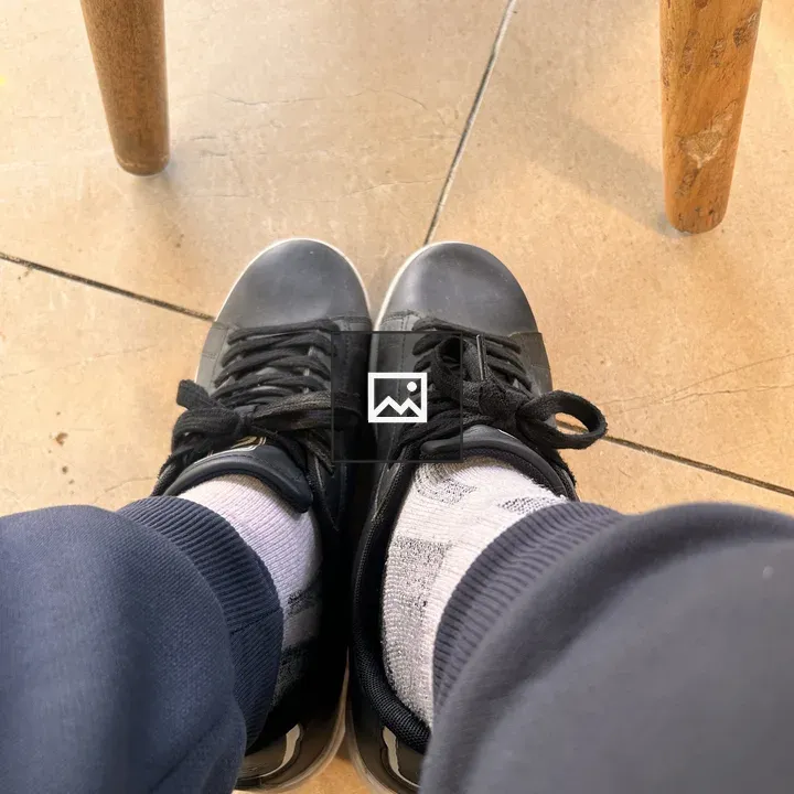 Person in Sneakers and Socks