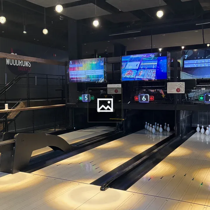 Indoor bowling alley with lanes and scoreboards