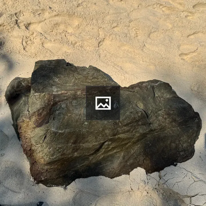 Rock on sandy beach