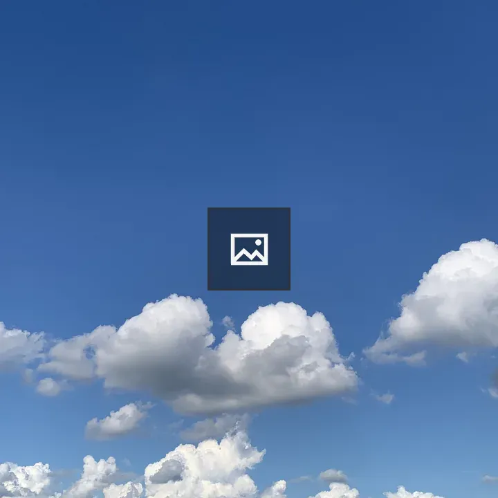 Distant rock formation under blue sky