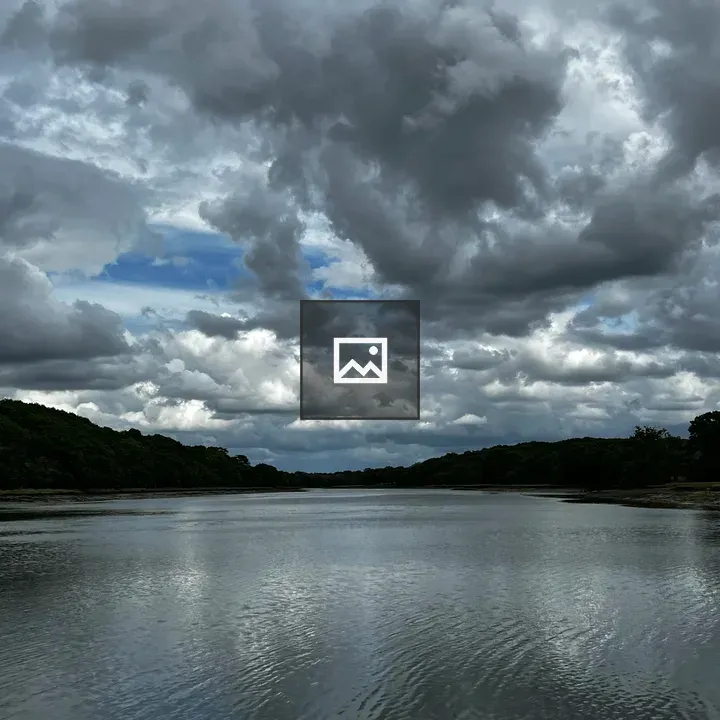 Water and Clouds Over Riverbank