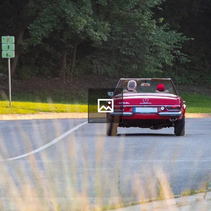 Couple in Red Convertible Car