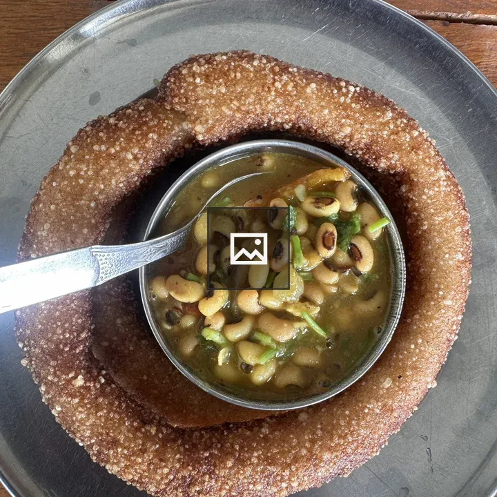 Sel roti with curry on table