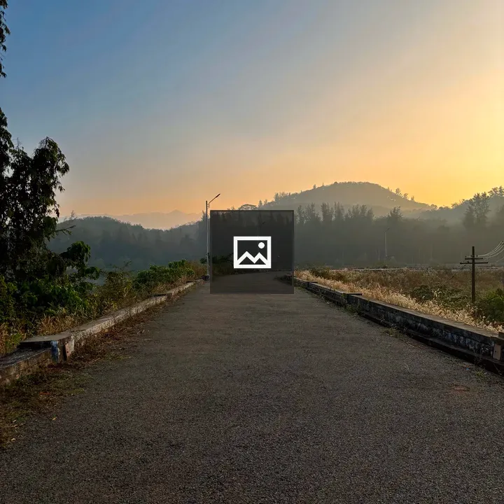 Road with silhouetted hills at dawn