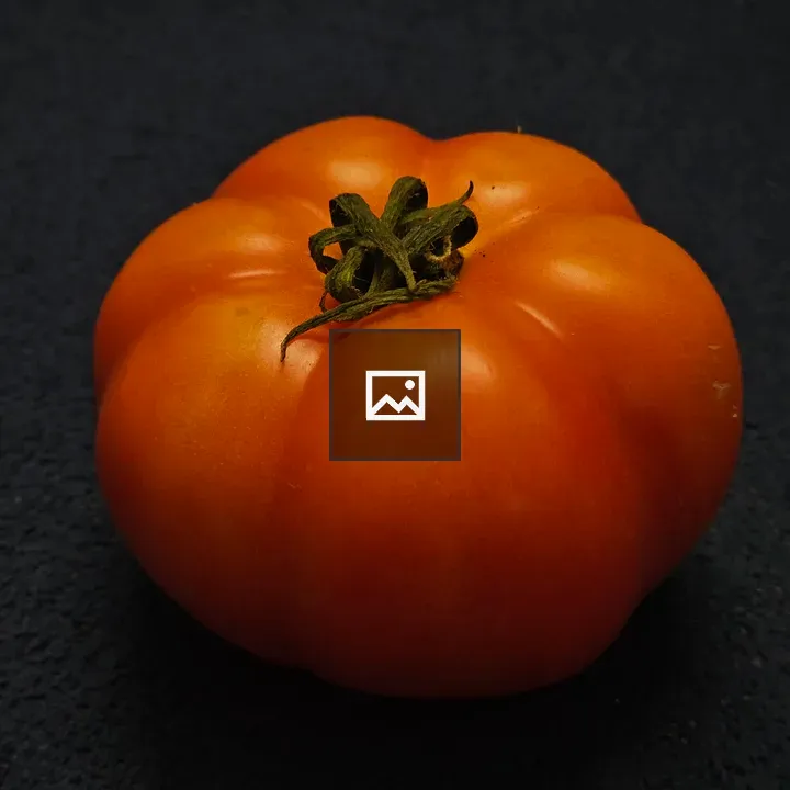 Fresh Red Tomato on Dark Surface
