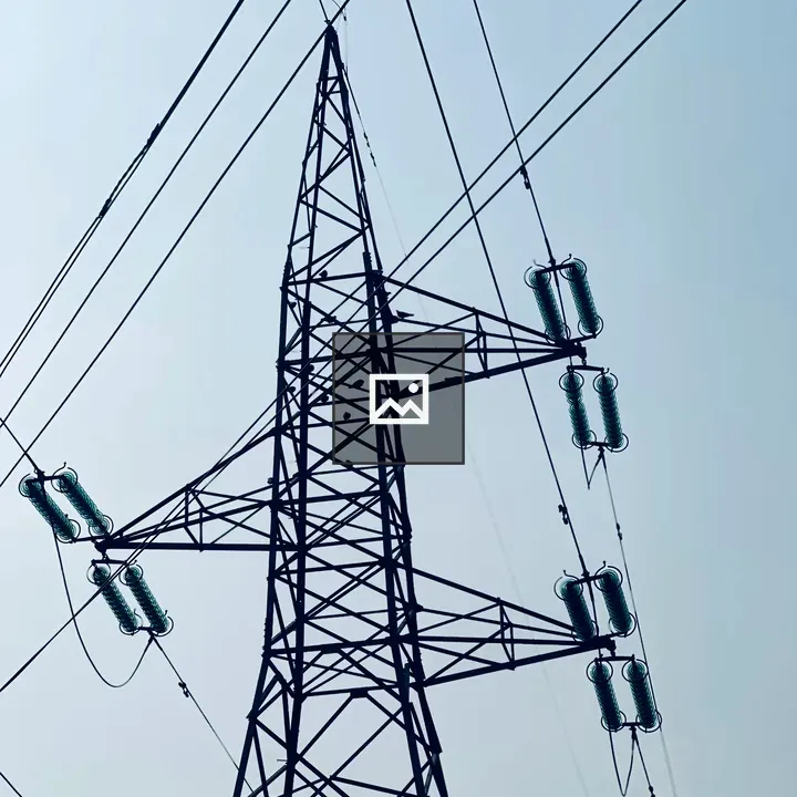 Tall transmission tower against blue sky