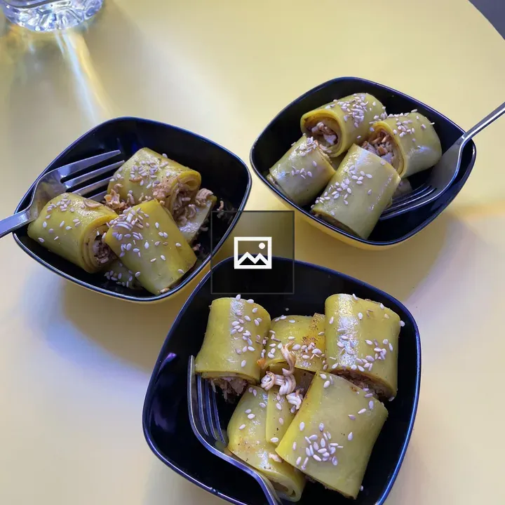 Three small black bowls with pastries