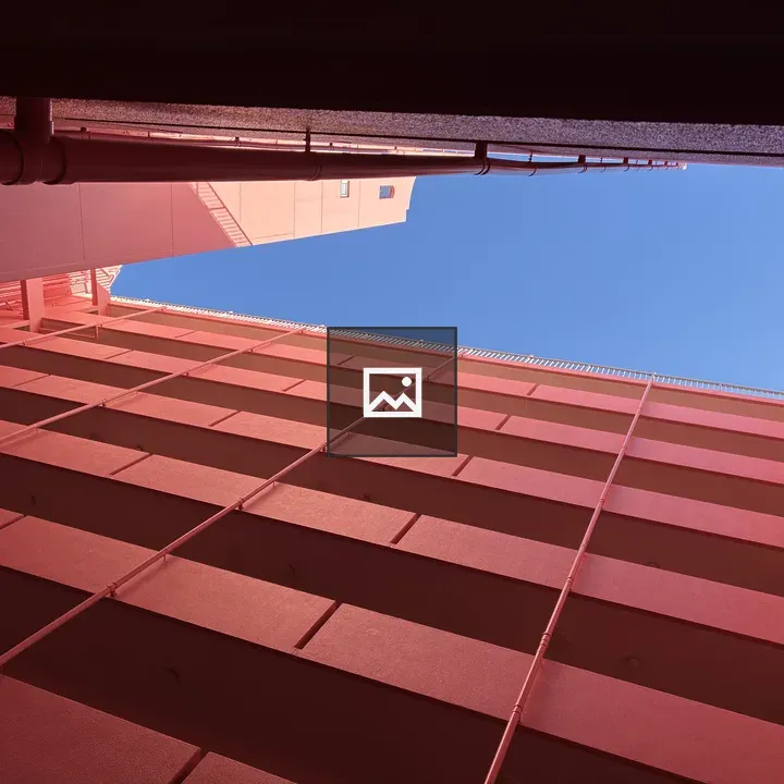 Gazing at blue sky from pink apartment atrium