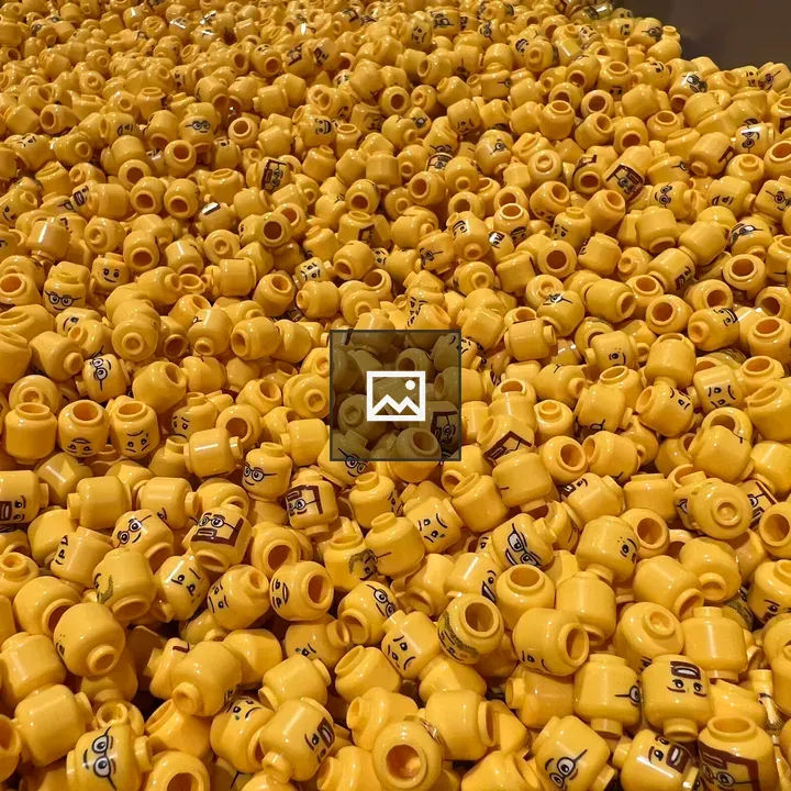 Lego character heads in a bin
