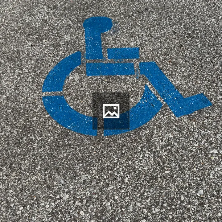 Outline of wheelchair user on pavement