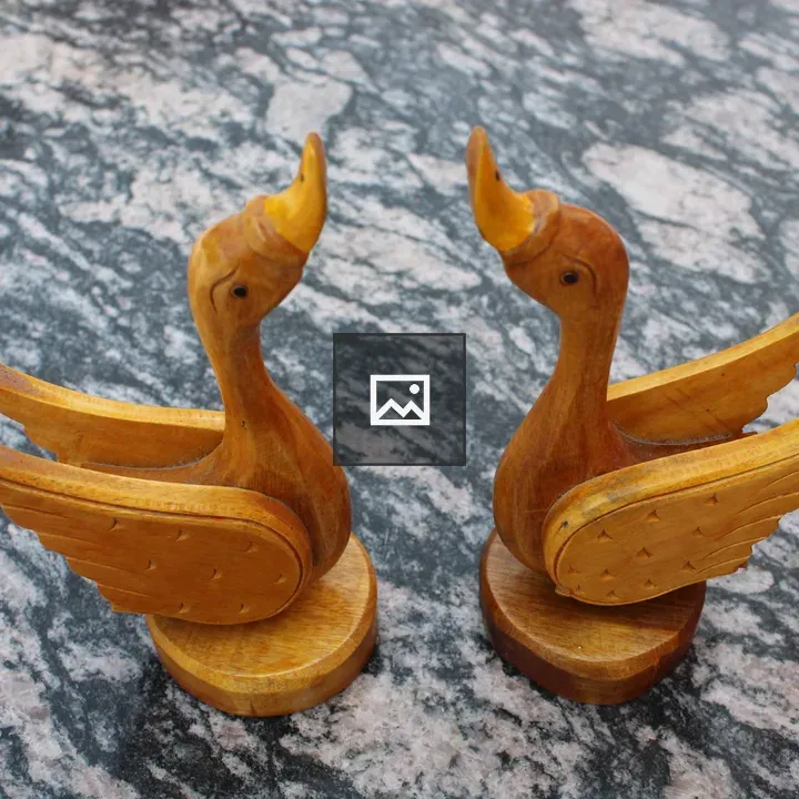 Two carved wooden duck figures