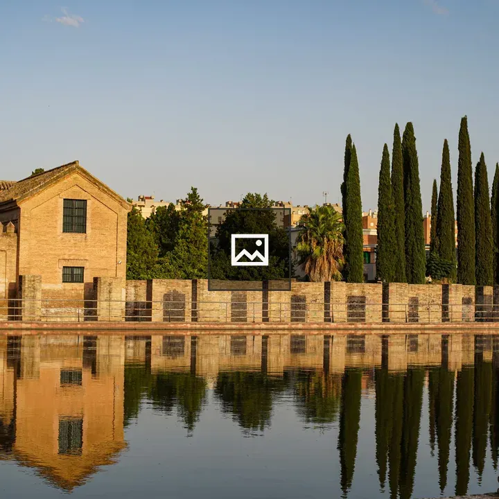 Historic brick building reflected in water