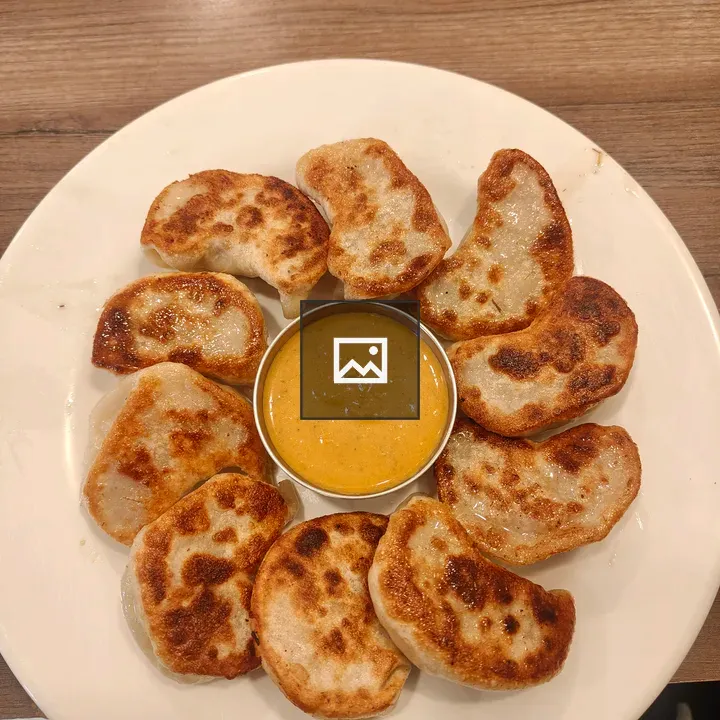 Plate of Dumplings with Sauce