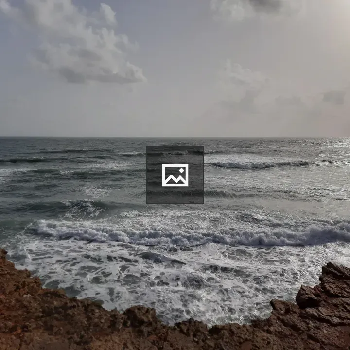 Rocky coastline with waves and clouds