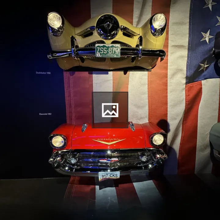 Wall display with vintage cars and flag