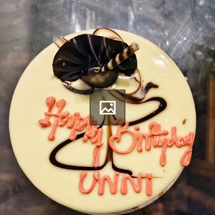 White birthday cake with pink icing