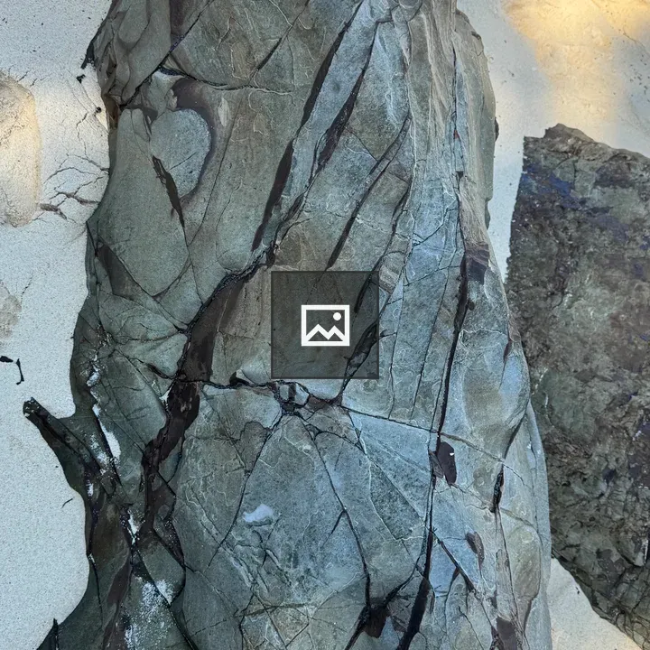 Rock with Deep Cracks on Beach