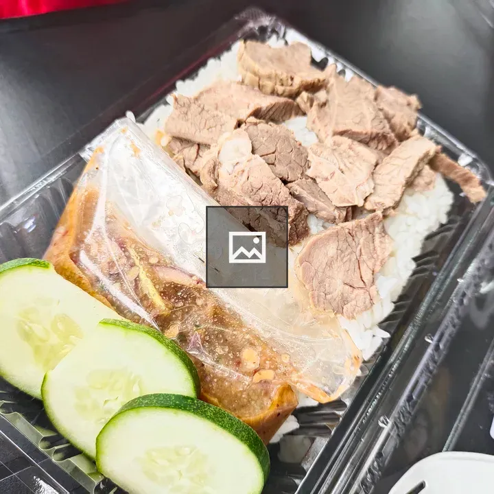 Plastic container with meat and rice