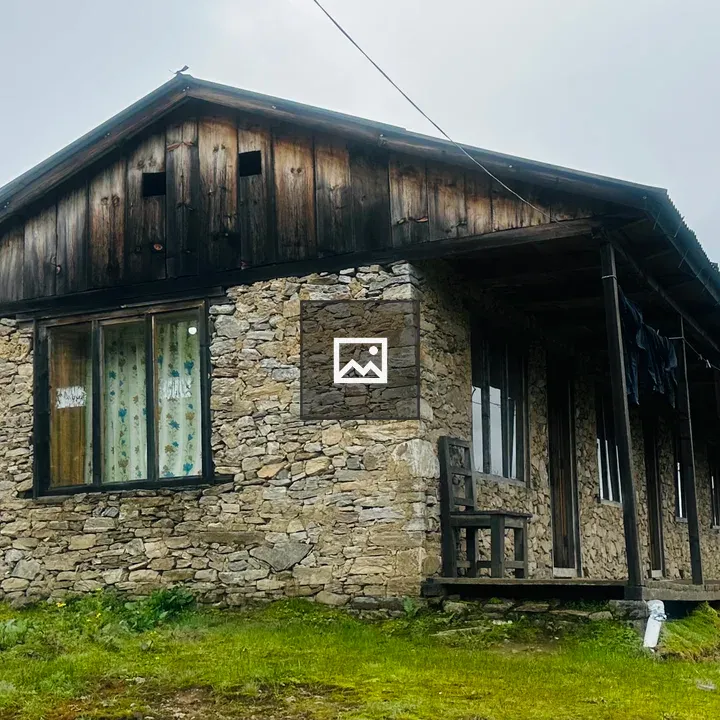 Rustic stone house with wooden roof