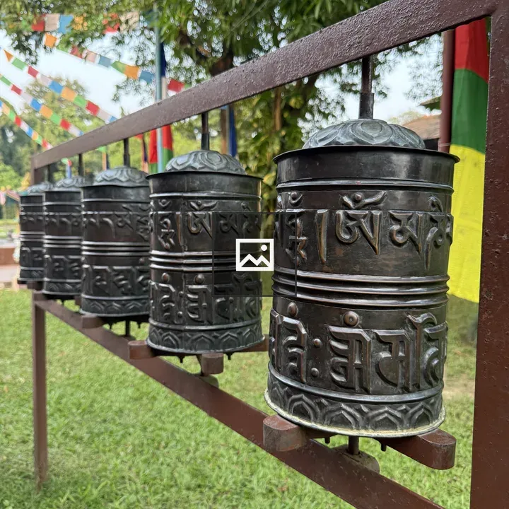 Prayer wheels on metal frame