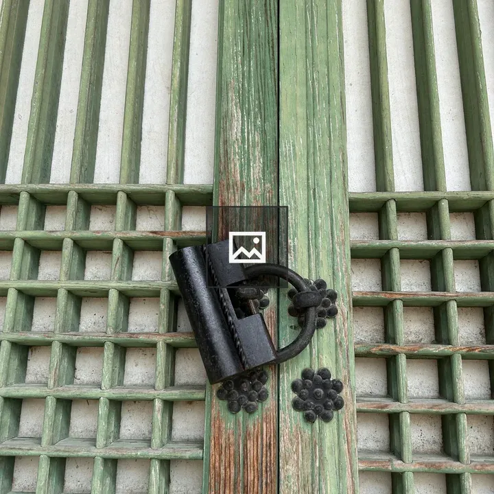 Weathered wooden door with green slats