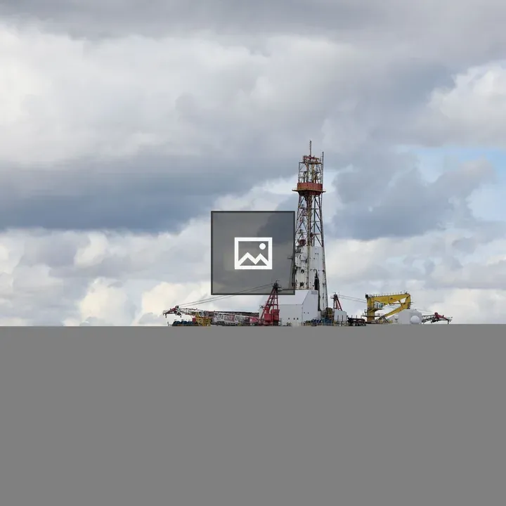 Oil rig with mountainous backdrop