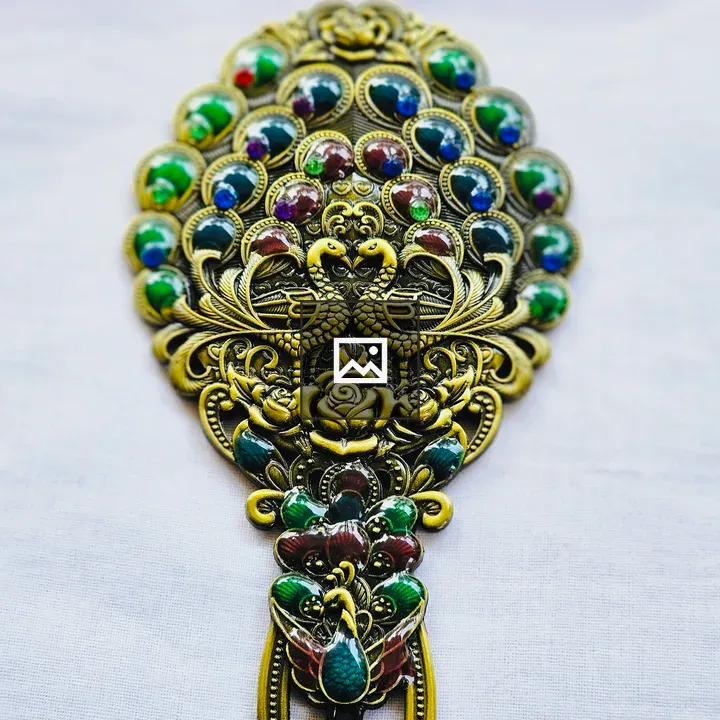 Ornate antique mirror with peacock motifs