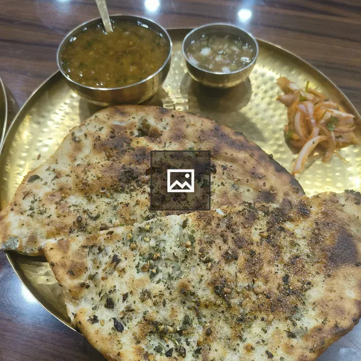 Golden plate with kulchas and chole