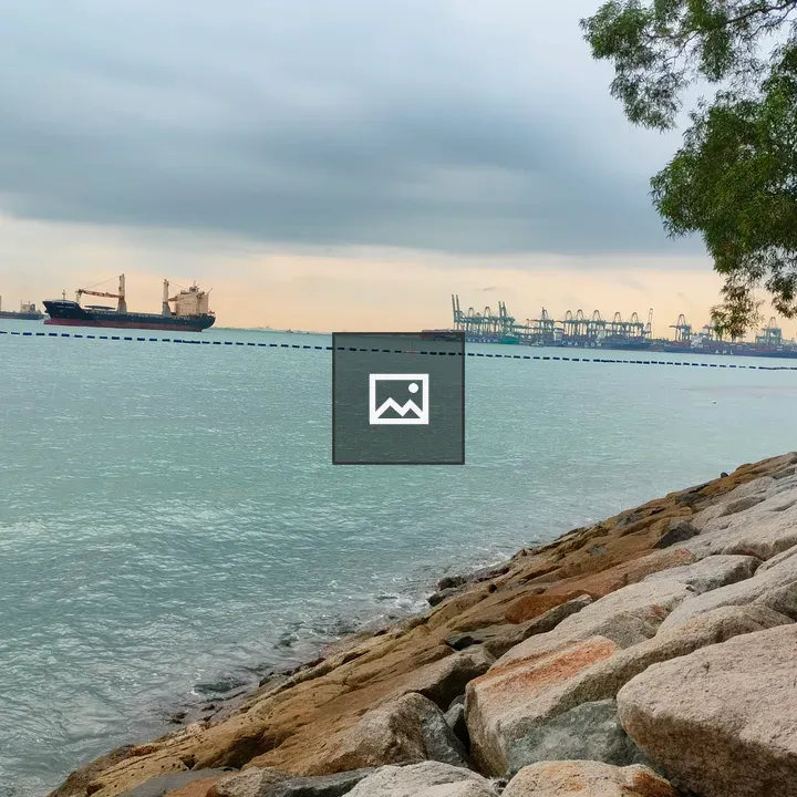 Rocky shoreline with ships