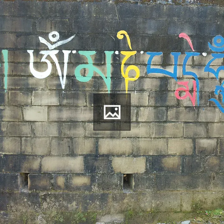 Mantra mural on weathered wall