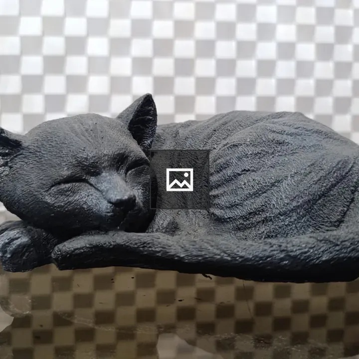 Black sculpture of sleeping cat
